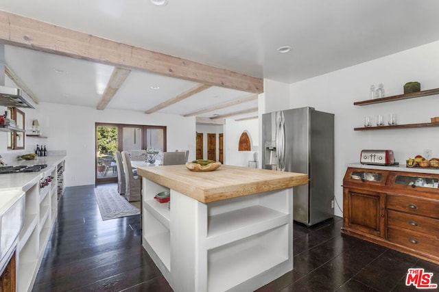 kitchen featuring beam ceiling, stainless steel fridge with ice dispenser, dark hardwood / wood-style flooring, wooden counters, and a kitchen island