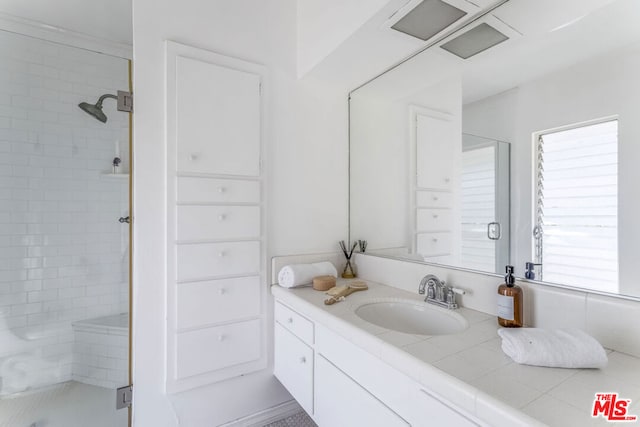 bathroom with vanity and a shower with shower door