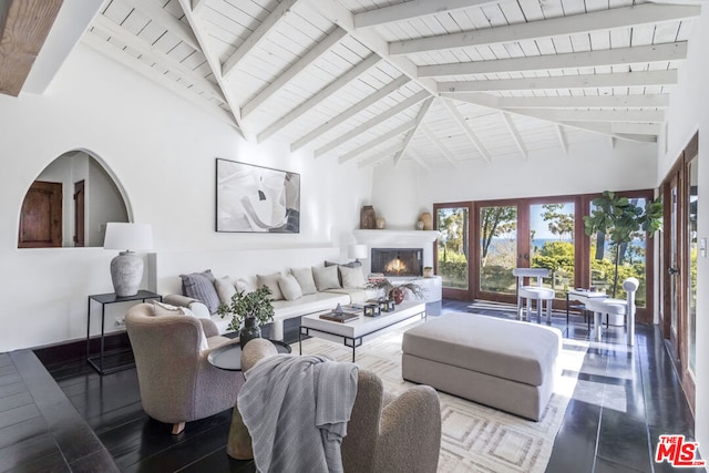 living room featuring beamed ceiling, high vaulted ceiling, and french doors