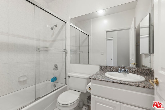 full bathroom with vanity, toilet, and bath / shower combo with glass door