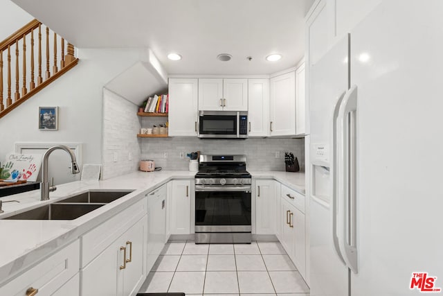 kitchen with white cabinetry, sink, light tile patterned floors, and appliances with stainless steel finishes