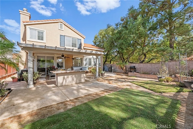 back of house featuring ceiling fan, a patio, exterior bar, and exterior kitchen