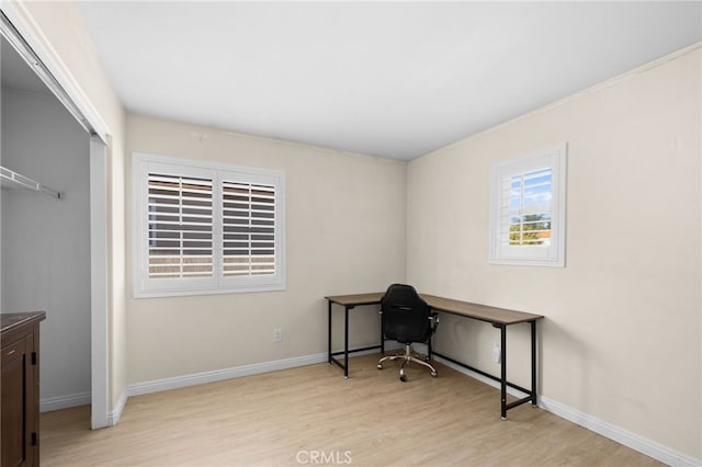 home office with light hardwood / wood-style floors