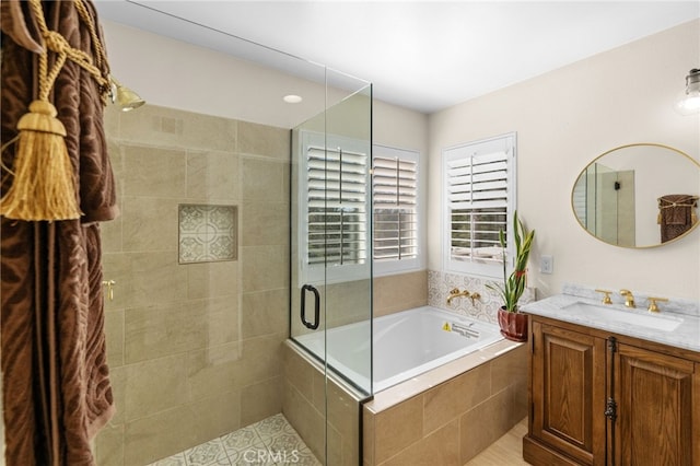 bathroom featuring tile patterned flooring, shower with separate bathtub, and vanity