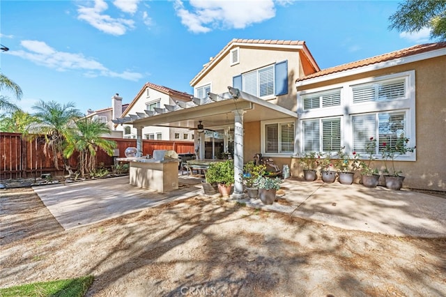 view of patio / terrace featuring a pergola and exterior kitchen