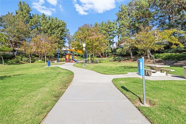 view of property's community with a playground and a lawn