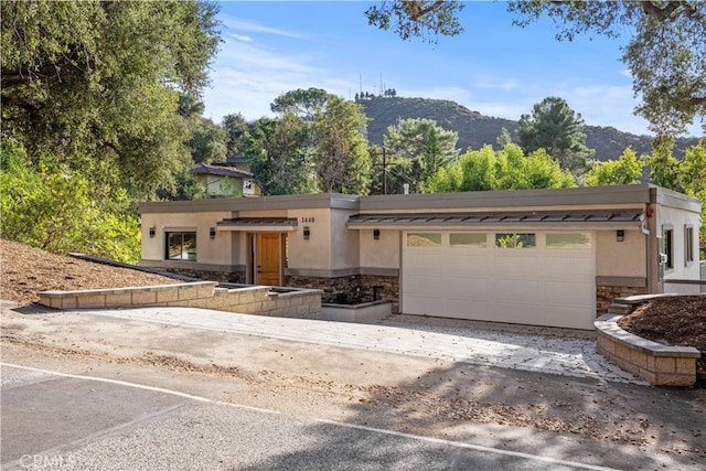 view of front of house featuring a mountain view and a garage