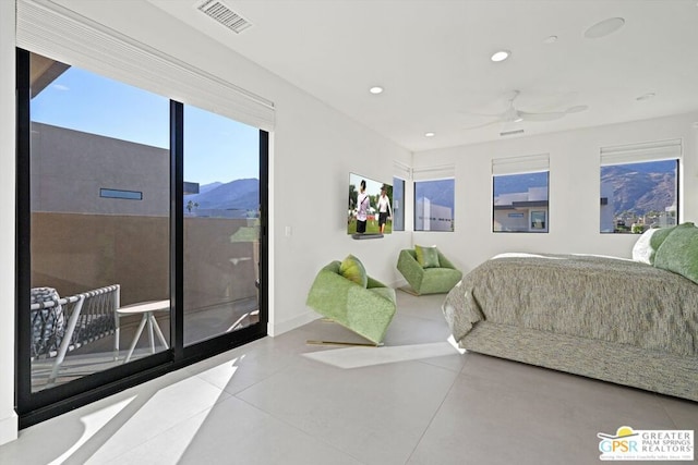 bedroom with a mountain view and ceiling fan