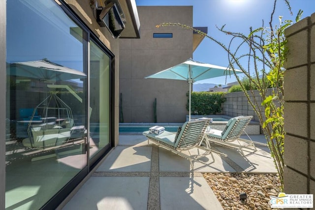 exterior space with a patio and a hot tub