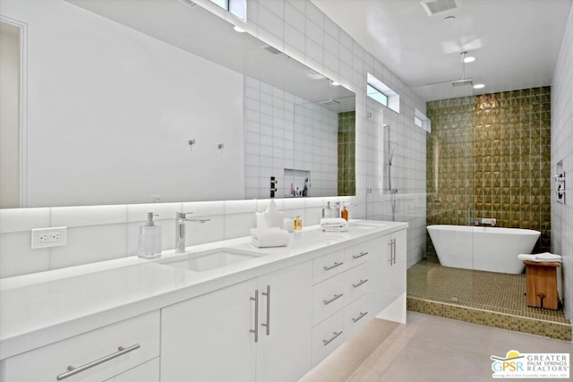 bathroom featuring tile patterned flooring, vanity, separate shower and tub, and tile walls