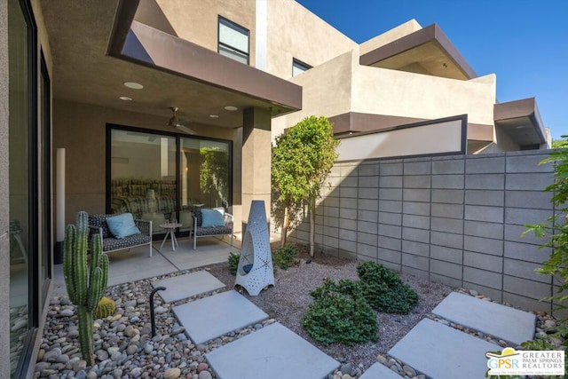 exterior space featuring ceiling fan