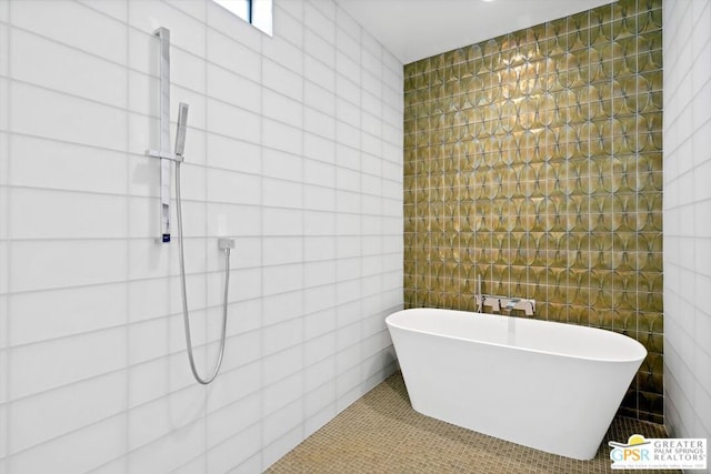 bathroom featuring tile walls and a bathing tub