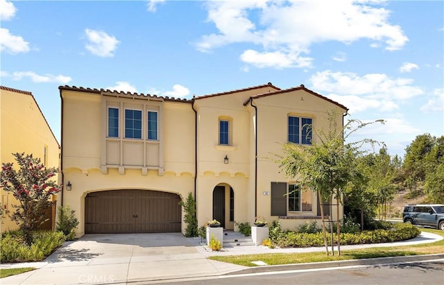 mediterranean / spanish home featuring a garage