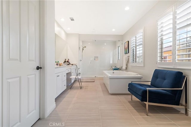 bathroom with tile patterned floors and separate shower and tub