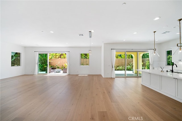 66 Poncho, Irvine, CA 92602 - unfurnished living room with recessed lighting and light wood finished floors