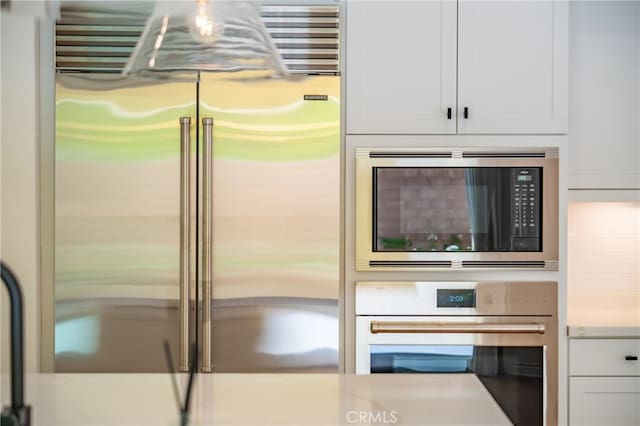 66 Poncho, Irvine, CA 92602 - kitchen view of built in appliances, white cabinetry, and light countertops