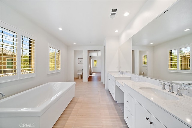 66 Poncho, Irvine, CA 92602 - bathroom featuring a tub to relax in, double vanity, and recessed lighting