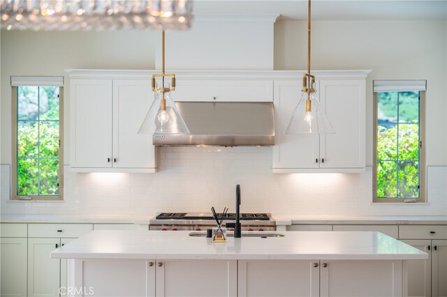 66 Poncho, Irvine, CA 92602 - kitchen with decorative backsplash, under cabinet range hood, and white cabinetry