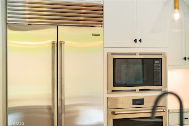 66 Poncho, Irvine, CA 92602 - kitchen view of built in appliances and white cabinetry