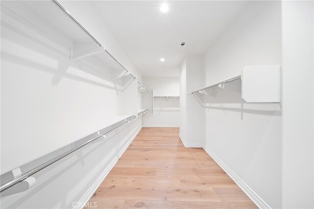 66 Poncho, Irvine, CA 92602 - walk in closet featuring light wood-style floors