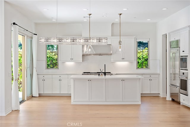 66 Poncho, Irvine, CA 92602 - kitchen with range hood, built in appliances, tasteful backsplash, light wood finished floors, and recessed lighting