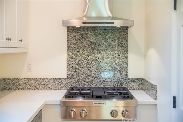 66 Poncho, Irvine, CA 92602 - kitchen view of wall chimney exhaust hood, stainless steel gas stovetop, light countertops, white cabinetry, and decorative backsplash
