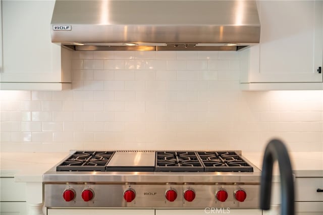 66 Poncho, Irvine, CA 92602 - kitchen with wall chimney range hood, luxury stove, backsplash, and white cabinets