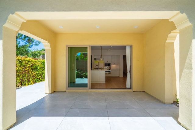 66 Poncho, Irvine, CA 92602 - view of exterior entry featuring stucco siding and a patio area