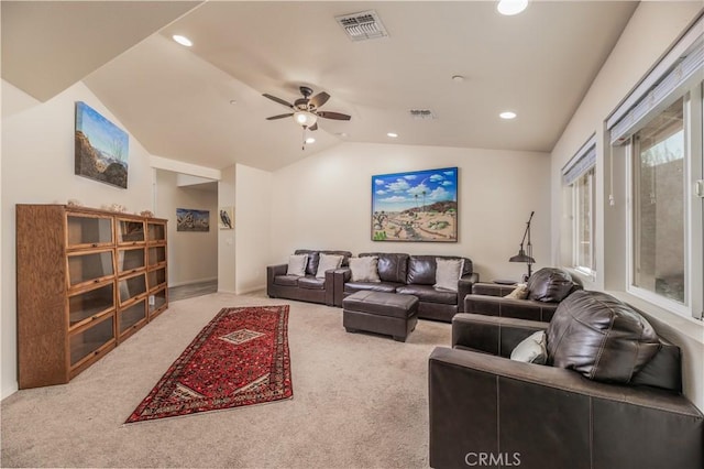 living room featuring ceiling fan, carpet floors, and lofted ceiling