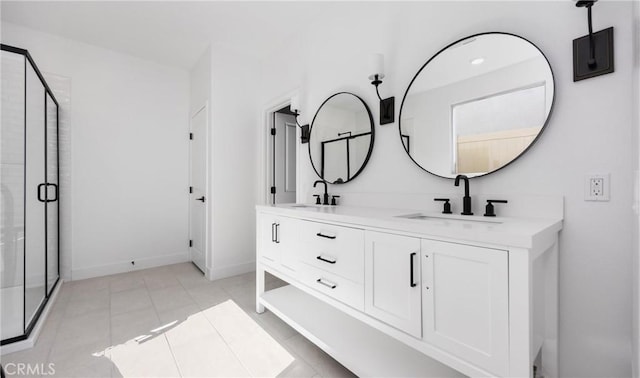 bathroom with a stall shower, tile patterned flooring, a sink, and double vanity