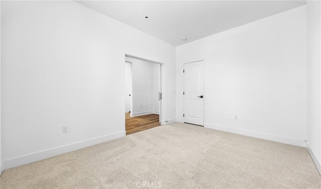 carpeted empty room with baseboards