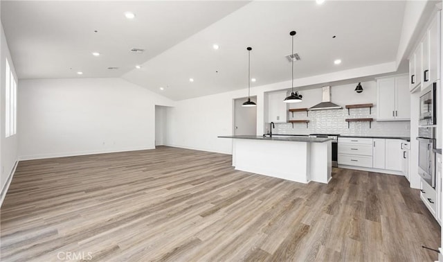 kitchen featuring dark countertops, white cabinetry, wall chimney exhaust hood, and open shelves