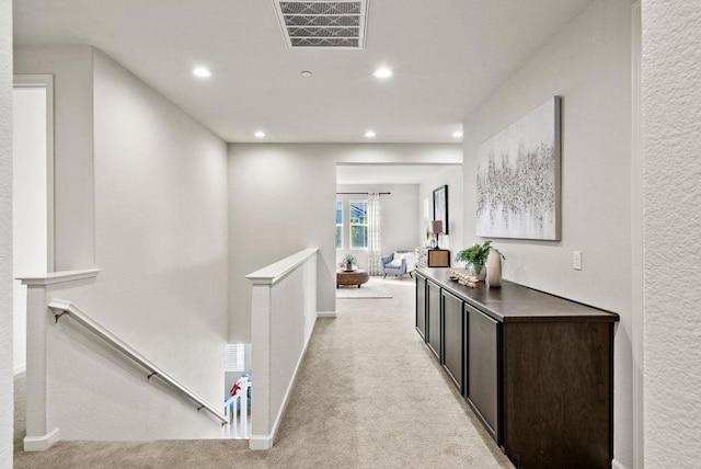 corridor with light colored carpet