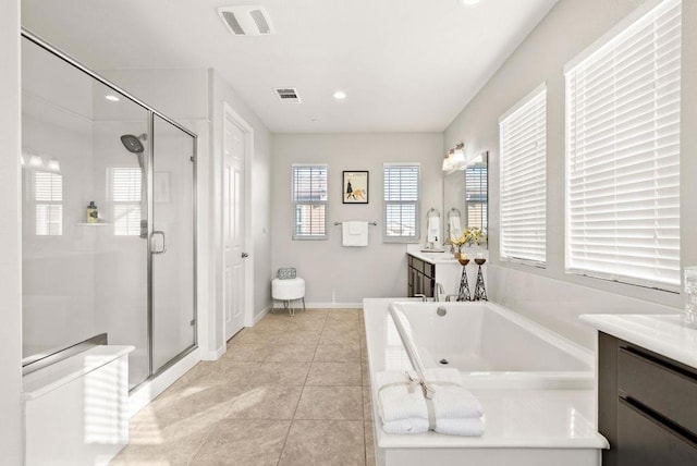 bathroom with tile patterned floors, vanity, and separate shower and tub