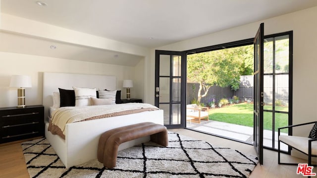 bedroom featuring access to exterior and light hardwood / wood-style floors