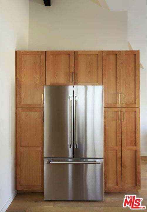 kitchen featuring light hardwood / wood-style flooring and stainless steel refrigerator