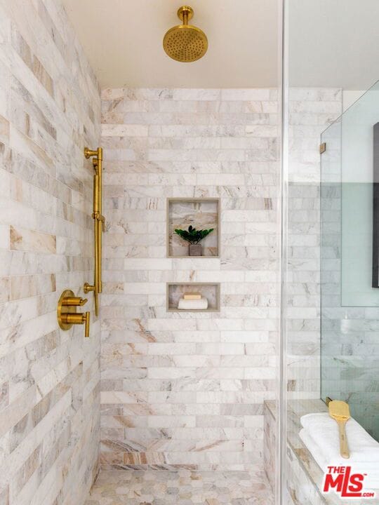 bathroom featuring a shower with shower door