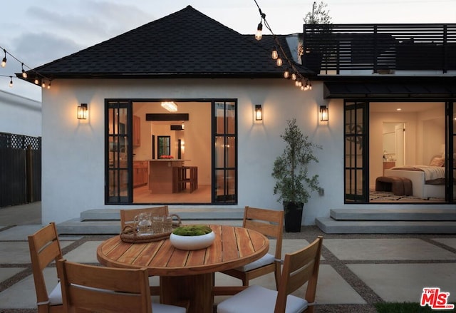 back of house featuring a balcony and a patio area