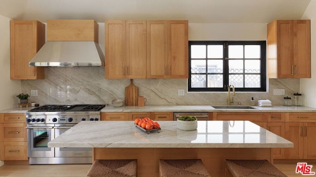 kitchen featuring appliances with stainless steel finishes, backsplash, wall chimney exhaust hood, and sink