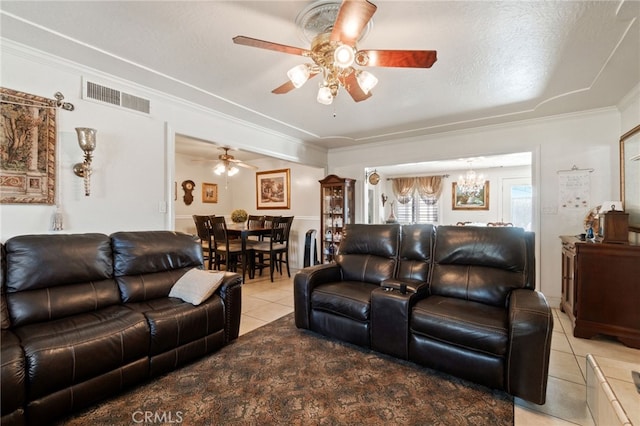 tiled living room featuring crown molding, ceiling fan, and a textured ceiling