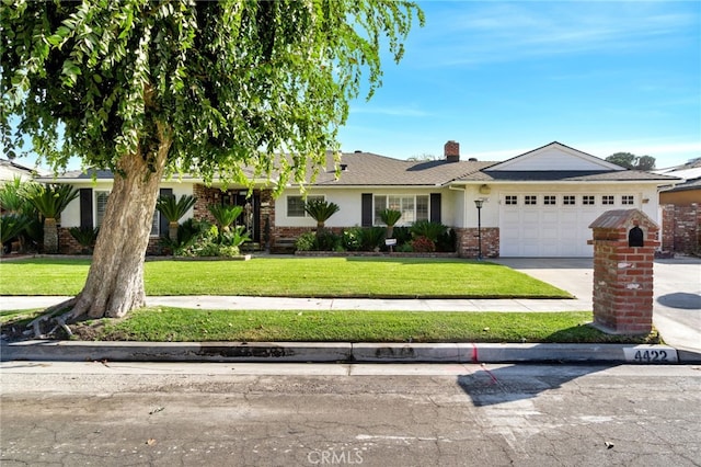 ranch-style home featuring a front yard and a garage