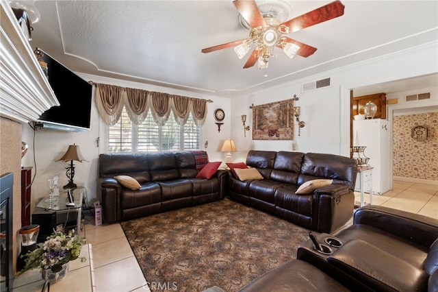 living room featuring tile patterned flooring, ceiling fan, and ornamental molding