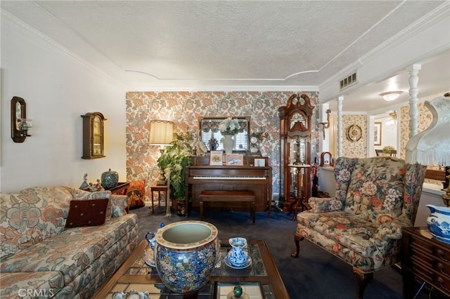 living room featuring ornate columns, a textured ceiling, and ornamental molding