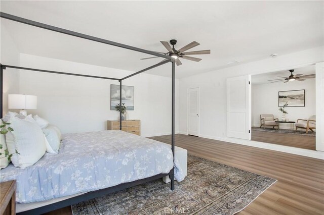 bedroom with ceiling fan and wood-type flooring