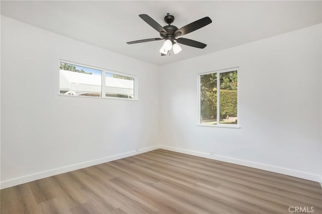 spare room featuring ceiling fan and light hardwood / wood-style flooring