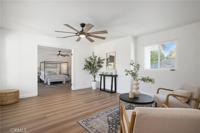 living room with hardwood / wood-style floors and ceiling fan