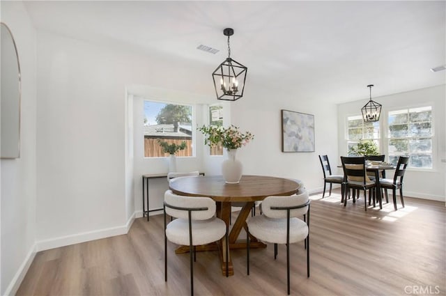 dining area with a chandelier and hardwood / wood-style flooring