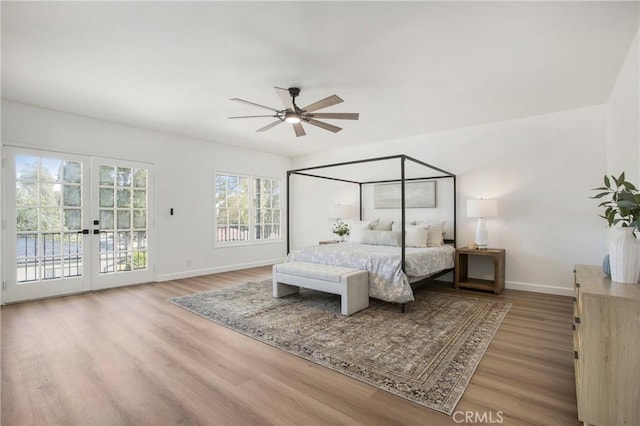 bedroom featuring access to outside, ceiling fan, hardwood / wood-style floors, and french doors