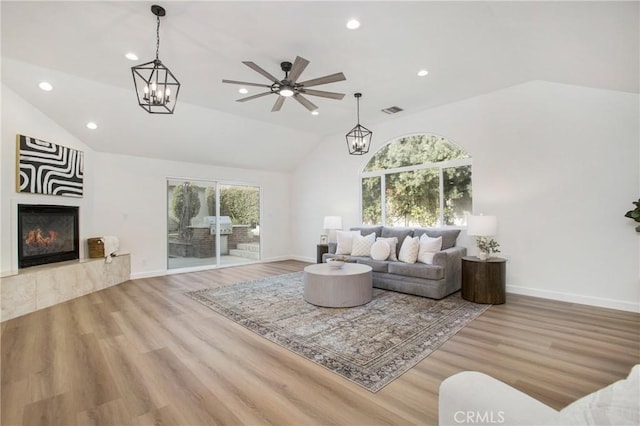 living room featuring ceiling fan, plenty of natural light, and light hardwood / wood-style floors