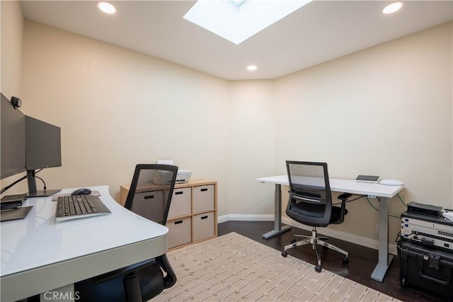 office featuring a skylight and dark wood-type flooring